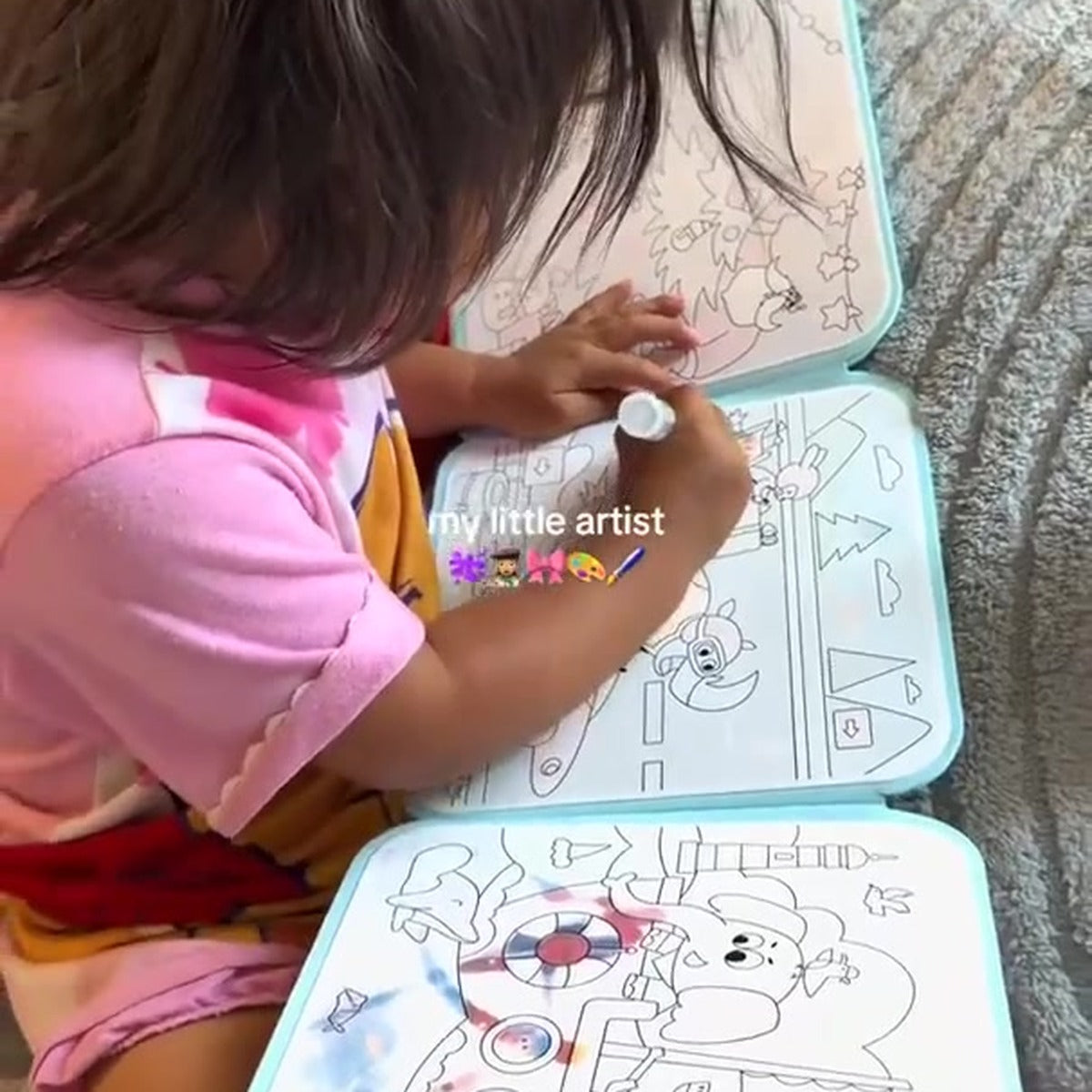 Child using the Magic Water Painting Book
